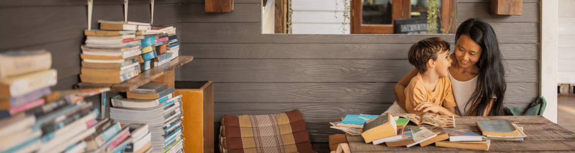 Nanny reading with a 3 year old boy who is laughing